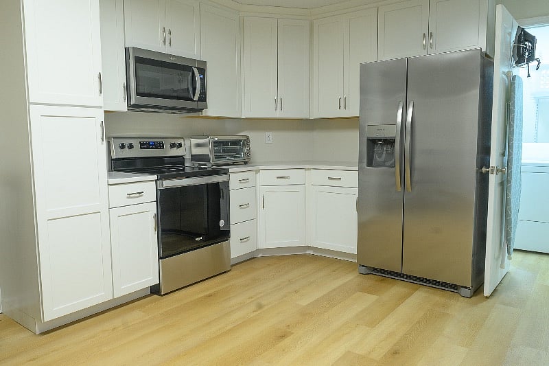 Full kitchen with refrigerator, stove, microwave, and dishwasher.