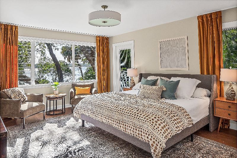 Master bedroom with private balcony overlooking water