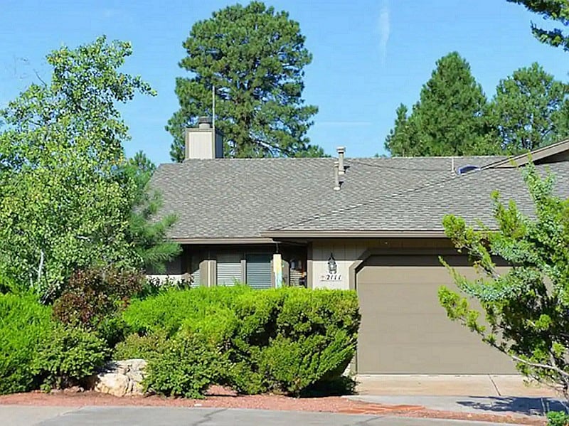 Front yard side entry of single level townhome.