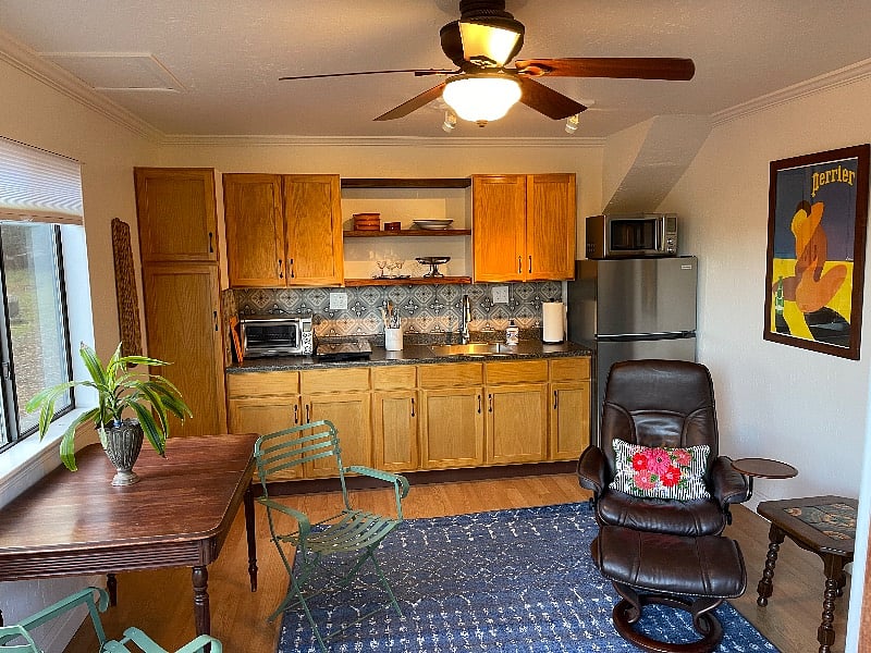 Kitchen area has a full size new LG fridge, microwave, induction stovetop, garbage disposer, and a Breville Austrailian XL countertop oven. Toaster oven, or chicken roaster, broiler, convection, cookie baking - it's big enough for about anything. There are new pots and pans and even good knives for the chef in you!  