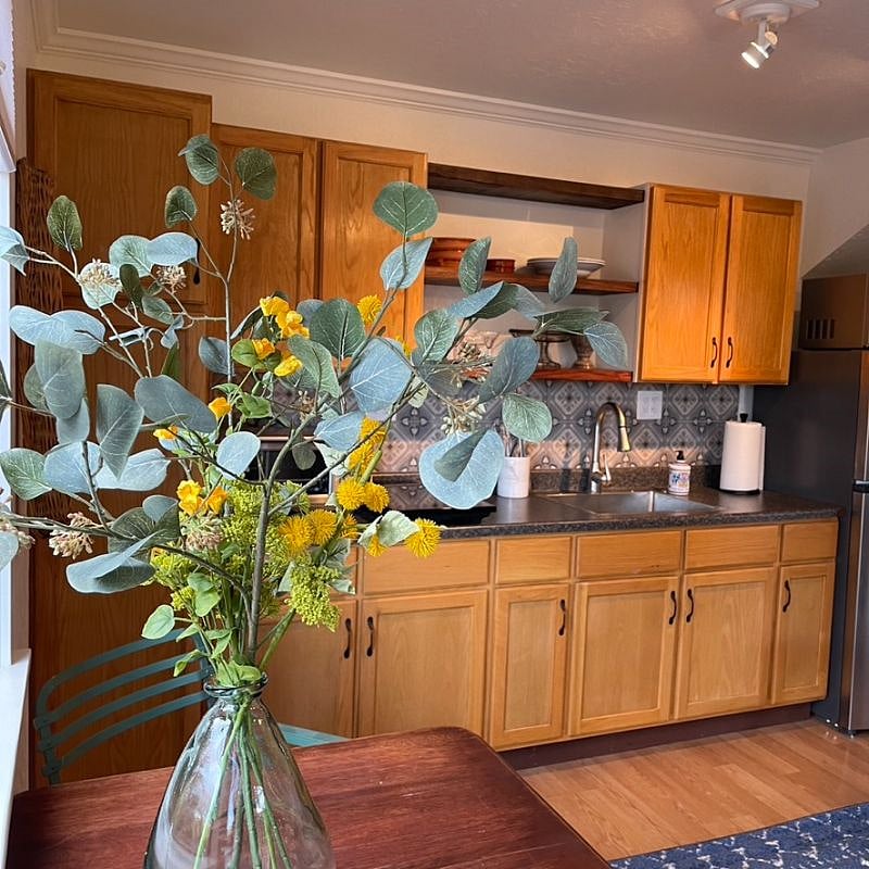 During Covid, I put in the Italian tile back splash (and in bathroom) and my father and I installed 3 big plank open shelves from makore wood from West Africa.
