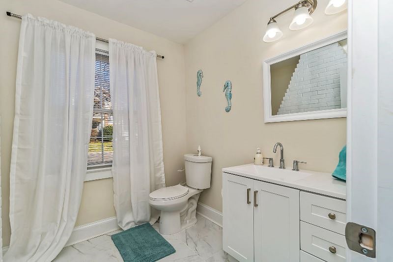 Half guest bath accessible in the main shared space.