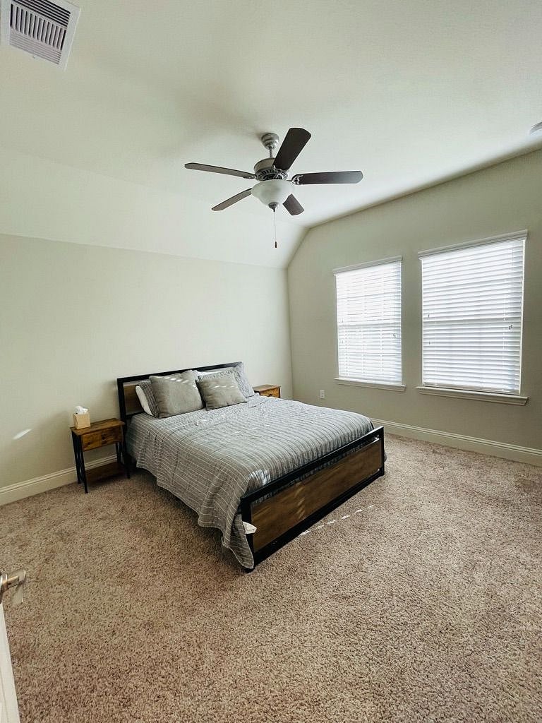 Secondary bedroom upstairs with queen size bed and attached bathroom