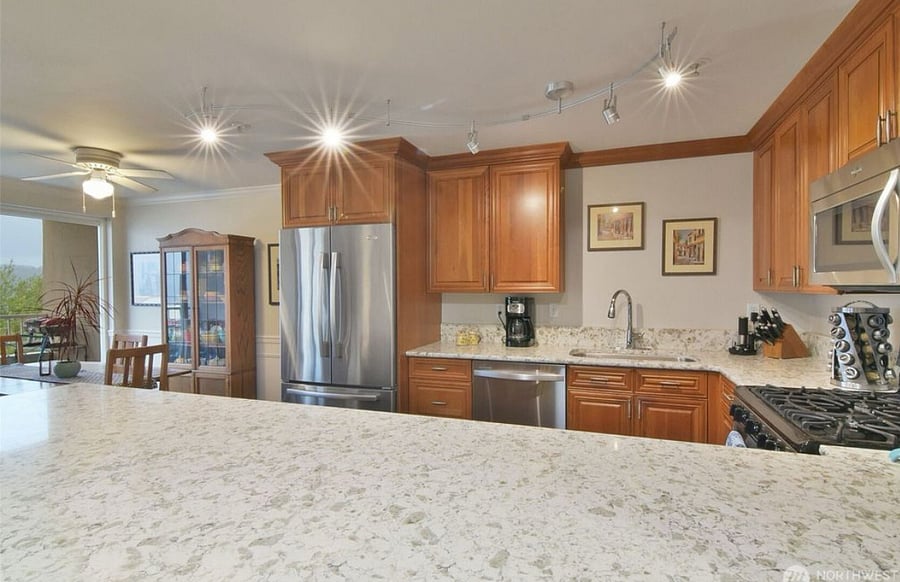 Stone countertops throughout kitchen.