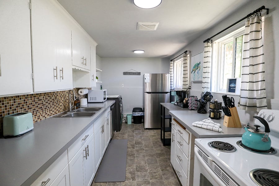 Kitchen, 4 burner stoves and oven, dishwasher, microwave, refrigerator, and coffee bar