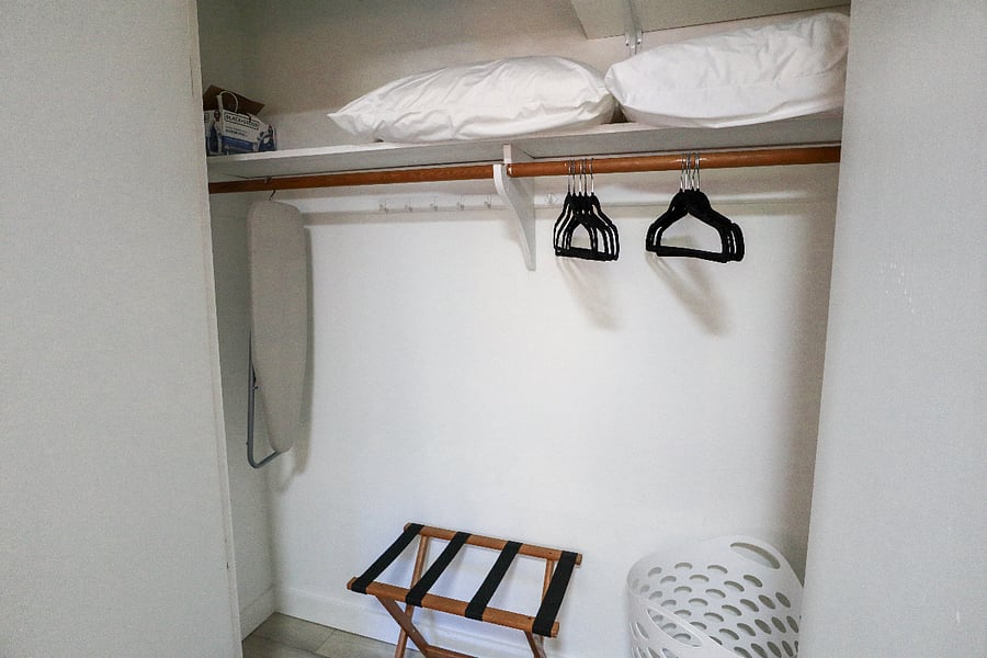 Bedroom 1 closet with hangers, iron and iron board