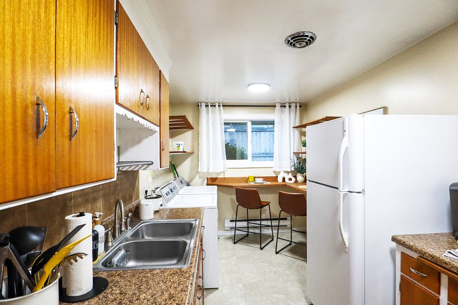 Kitchen; refrigerator, microwave, silverware, utensils, 4 burner stoves, and oven.