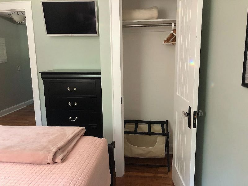 Spare bedroom closet with luggage rack/clothes hamper
