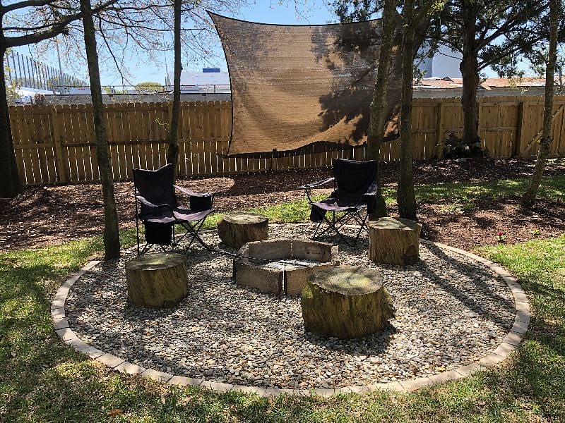 Backyard fire pit. Camping chairs are in the shed.