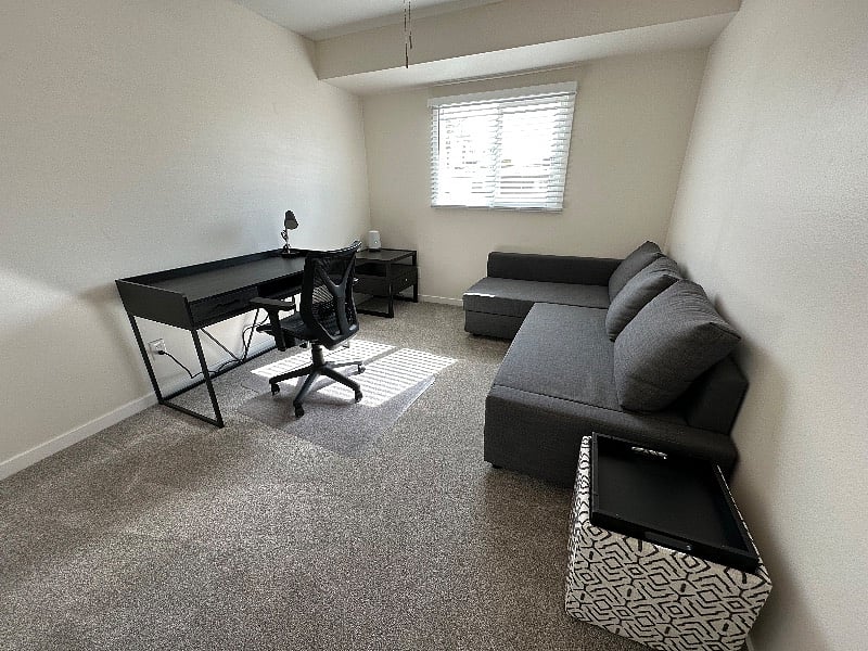 3rd Bedroom with desk and a chair. Ikea sectional  turns into a queen bed.