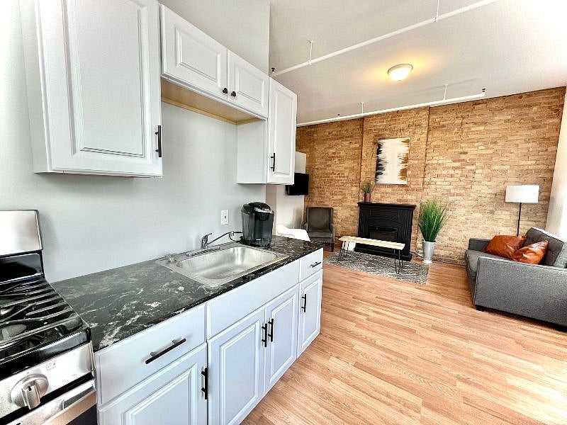 Kitchen with new stainless steel appliances and full sized refrigerator