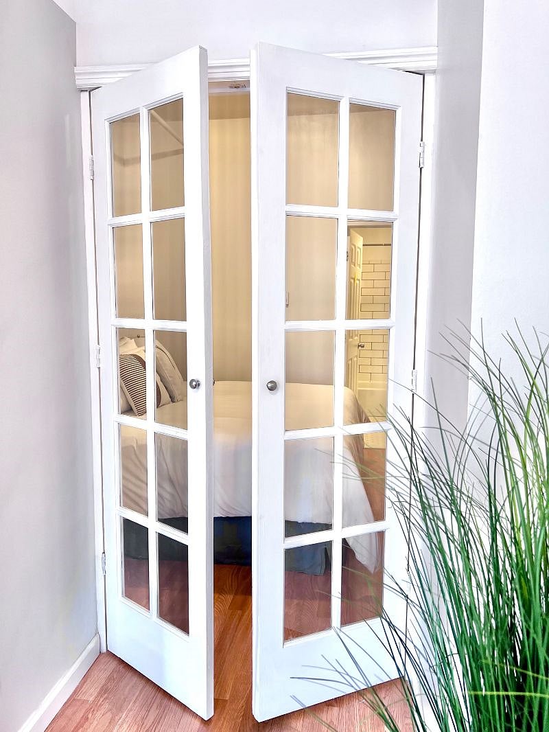 French doors leading from living room into bedroom