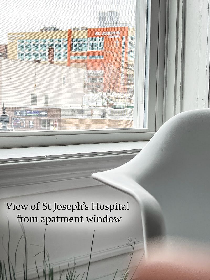 View from the apartment window showing St Josephs Hospital / Trinity Health (located on the block across the street) .