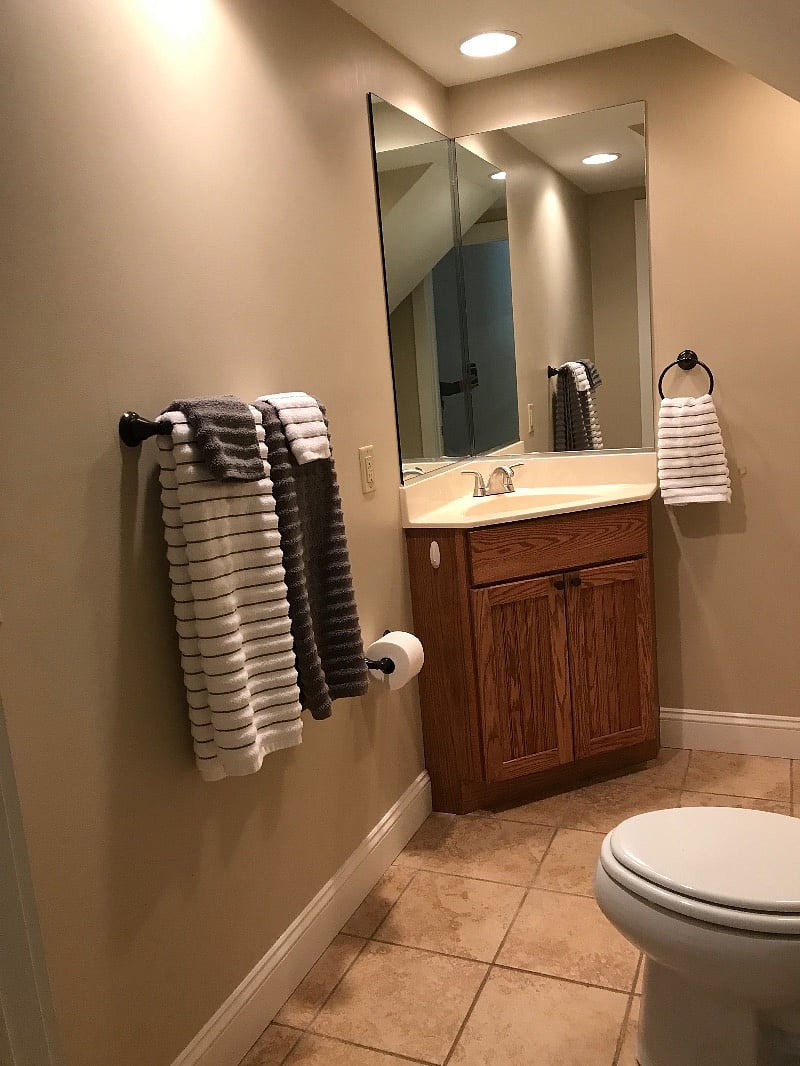 Bathroom with shower and tiled floor.