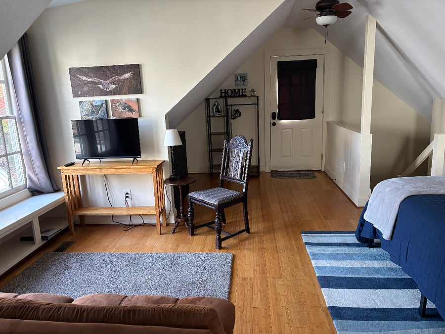 View from kitchen area to the exit door. Stairs on left go to bathroom.