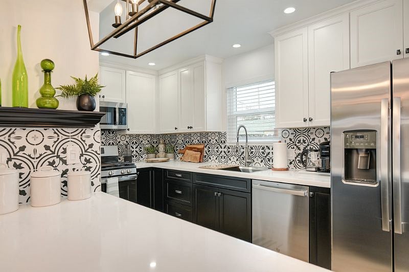 Quartz counters full designer tiled backsplash