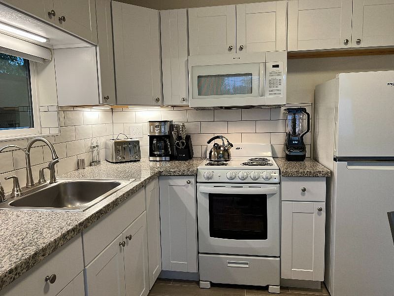 Well equipped kitchen has everything you need to cook delicious meals at home - complete with pots, pans, dishes, cutlery, etc.