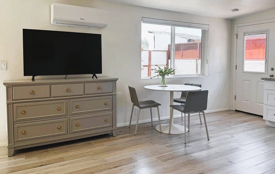 Living area - dresser with ample storage space and 50" smart TV