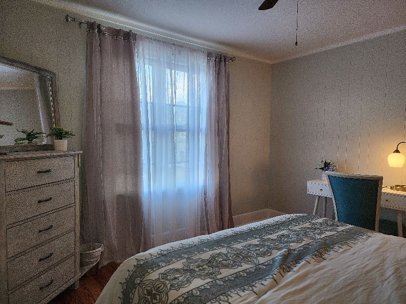 Front Room Bed with view of desk and Window