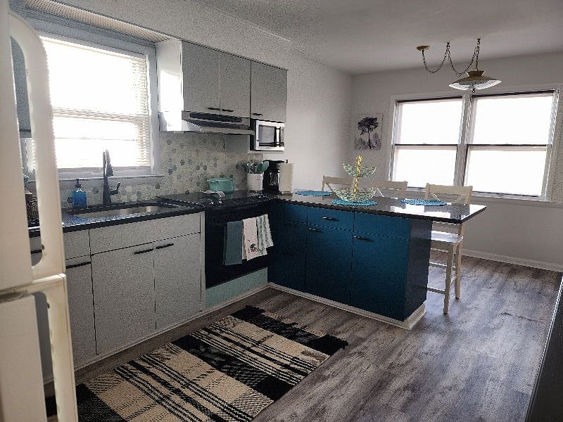 Kitchen View with Full Stove and Refrigerator