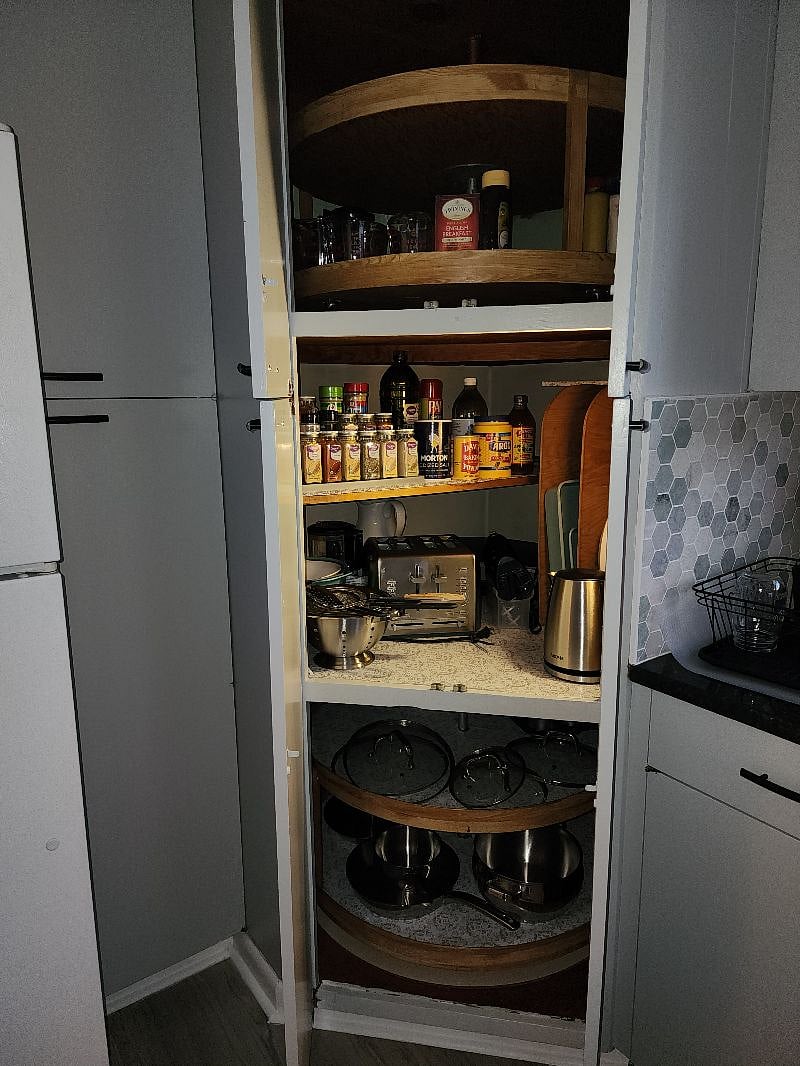 Full Pantry with Spices, pots, serving dishes, toaster, and cutting boards.