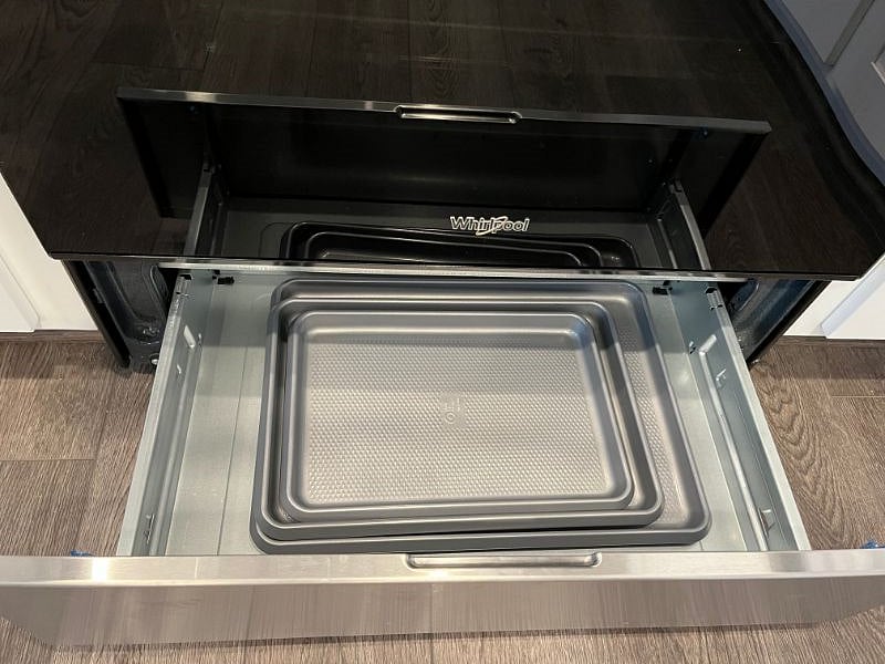 cookie sheets in bottom of stove