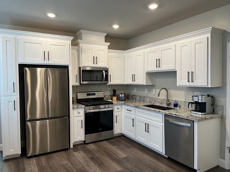 Kichen with full size fridge, stove, dish washer, farm style sink, microwave. All utensils, cookware and dishes provided