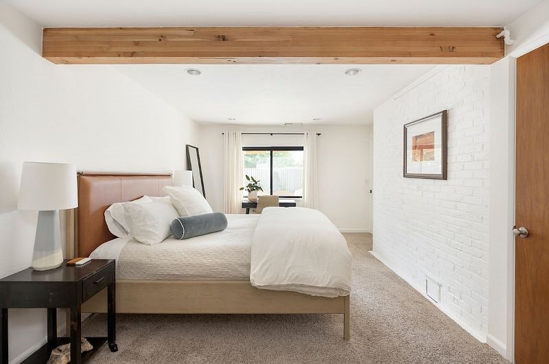 Primary bedroom is large, light and bright. Features a king-sized bed, desk, closet, dresser, lounge area and TV with Roku 4k+ streaming device.
