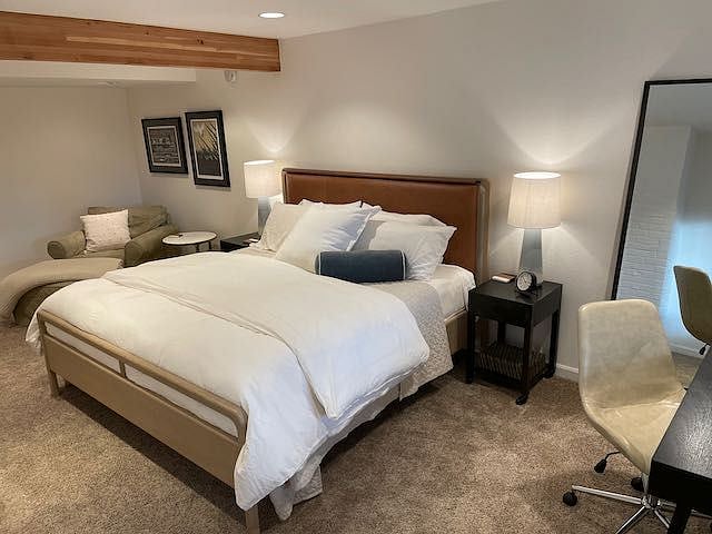 Primary bedroom is large, light and bright. Features a king-sized bed, desk, closet, dresser, lounge area and TV with Roku 4k+ streaming device.