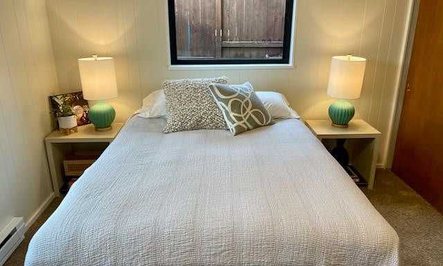 2nd bedroom features queen sized bed, closet, dresser, lounge chair. Access to utility area with washer & dryer as well. (not pictured)