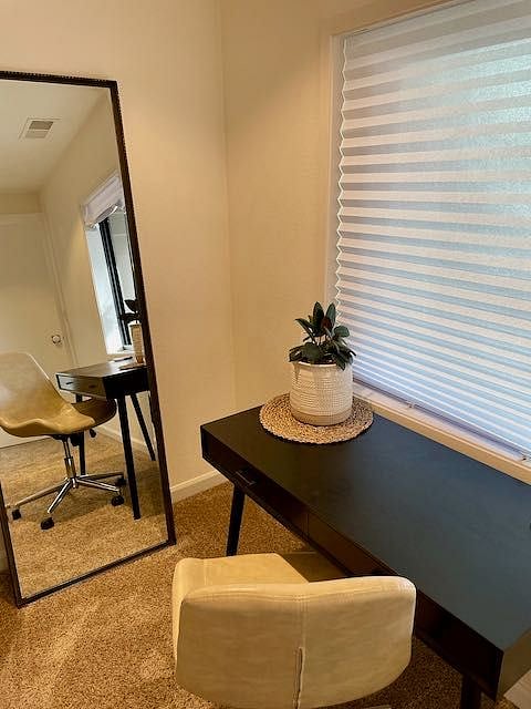 Primary bedroom is large, light and bright. Features a king-sized bed, desk, closet, dresser, lounge area and TV with Roku 4k+ streaming device.