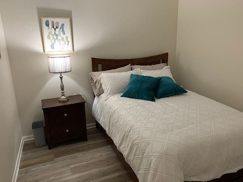 Full size comfortable bed with nightstand & good lighting