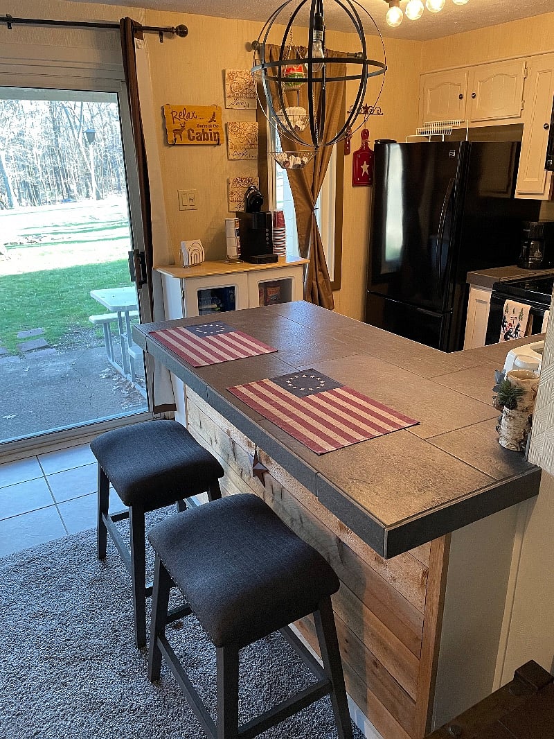 Breakfast Bar looking out to the patio with a charcoal grill, fire pit, and picnic table. Quiet, relaxing, and pet friendly.