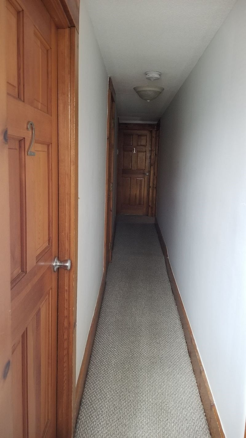 second floor hallway leading to # 1 bigger room and full bathroom with washer and dryer.