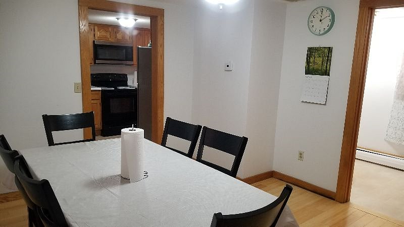 dining room on first floor with kitchen in the background and bathroom next to the dining room