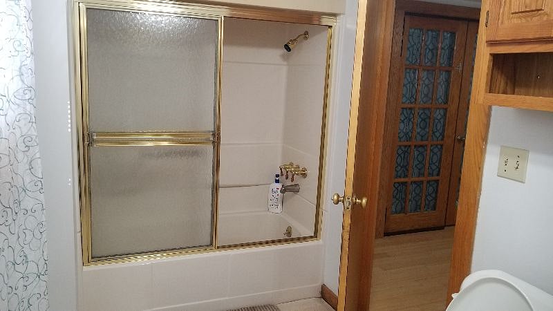 shower bathtub combo in the bathroom on the first floor
