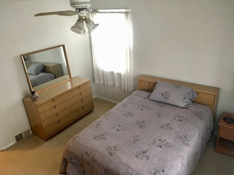alternate angle, features two dressers and two closets with a 32' Smart TV