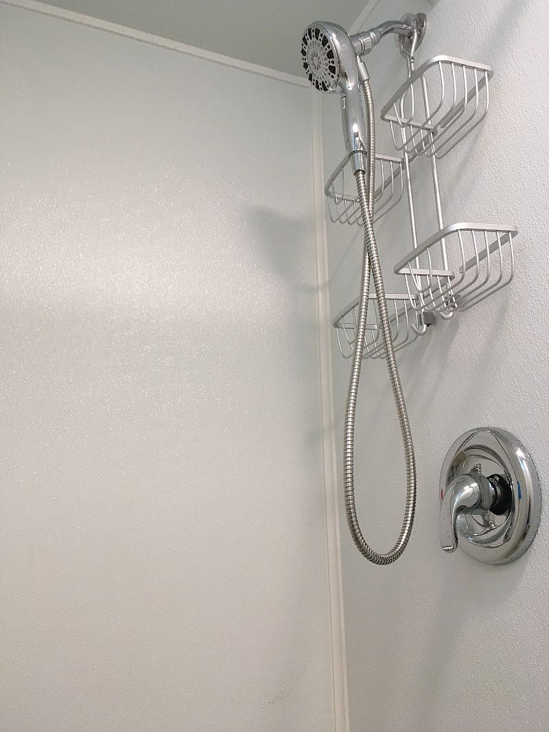 Basement Bathroom Shower featuring detachable hand-held shower head.