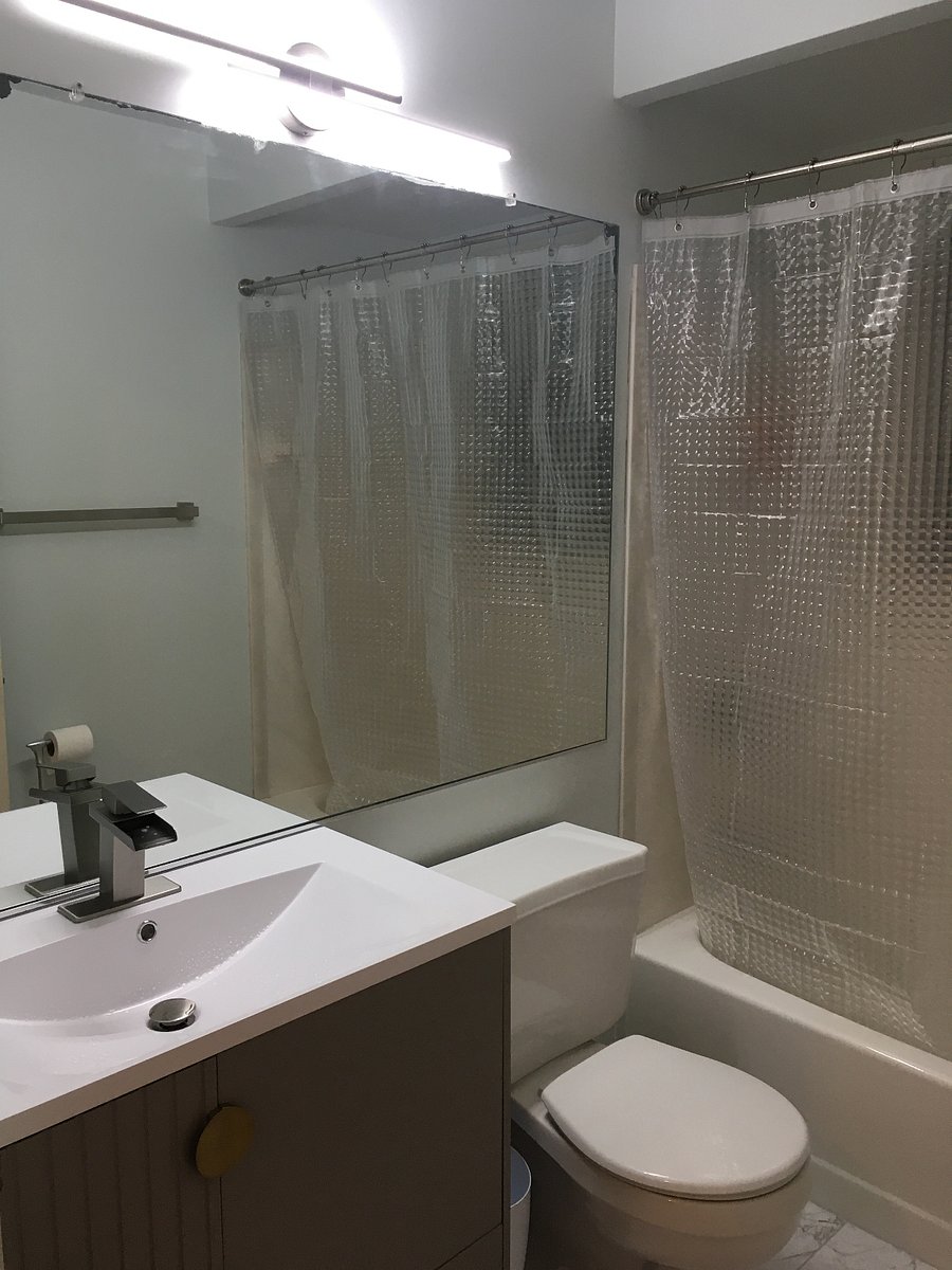 Updated Main Bathroom with fresh linens and starter toiletries. Angled doorway view