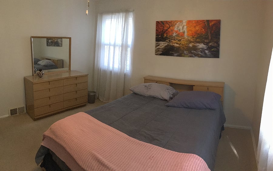 Summertime capture of an alternate angle, features full bed, two dressers and two closets with a 32' Smart TV