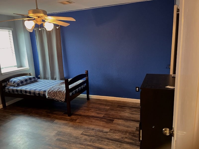 bedroom number two. single bed with dresser and closet space.