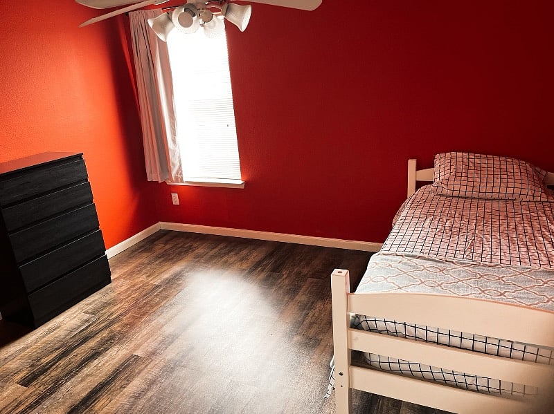 bedroom number three. single bed with dresser and closet space.