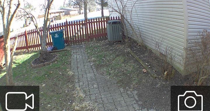 Back gate view / garbage 36 gal can to with weekly trash pick up from curb. Newly sowed grass seed and dirt.