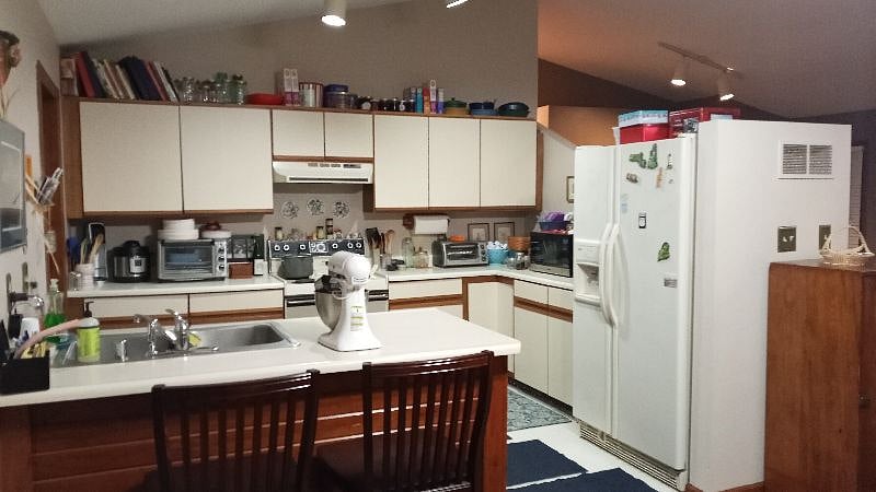 Full kitchen including dishwasher next to sink. Tile flooring