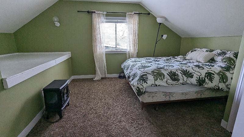 Upstairs bedroom with Queen Bed and carpet.