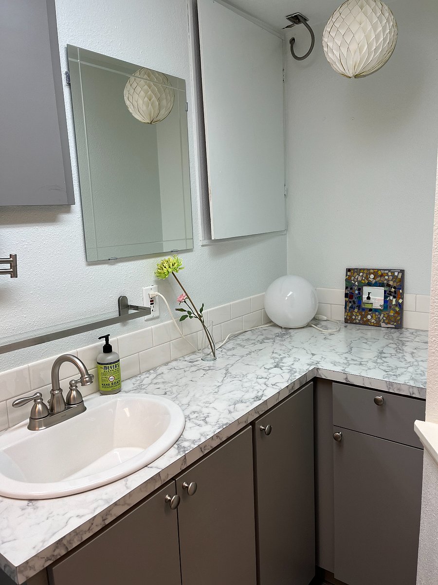 Bathroom shares space with the washer & dryer.sh
