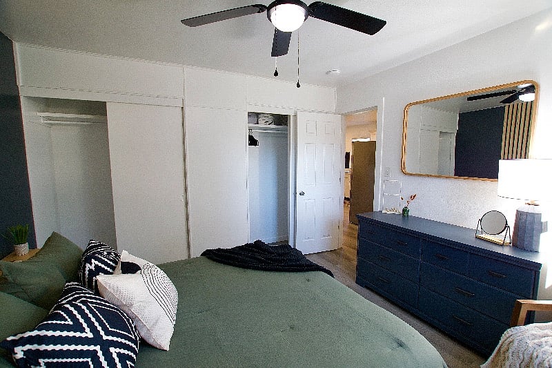 The closets have hangars and additional storage space on the shelves.