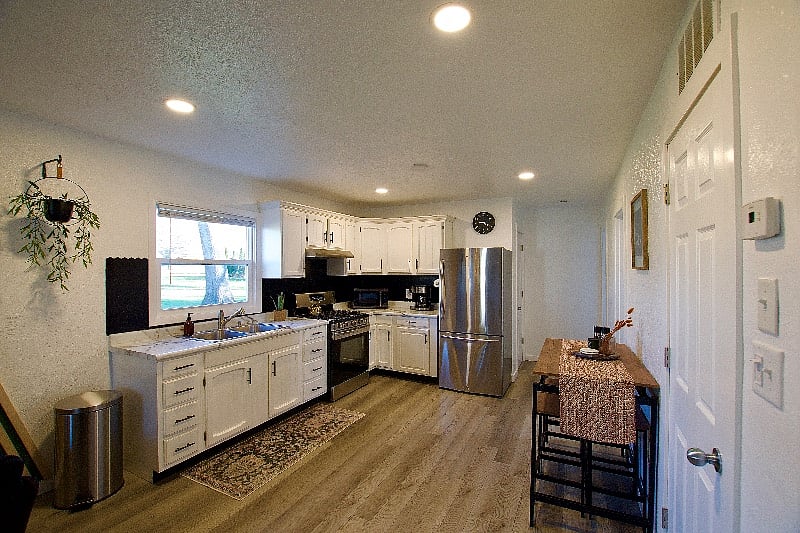 The kitchen is fully furnished with with pots, pans, cooking utensils, plates, cups, bowls, silverware, etc.