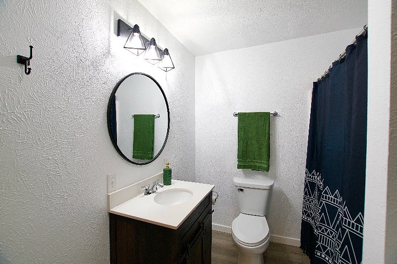 The vanity contains storage space for personal items.
