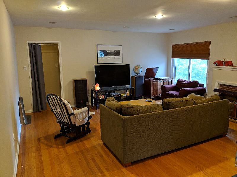 Spacious living room with a large screen TV connected to high-end speakers.